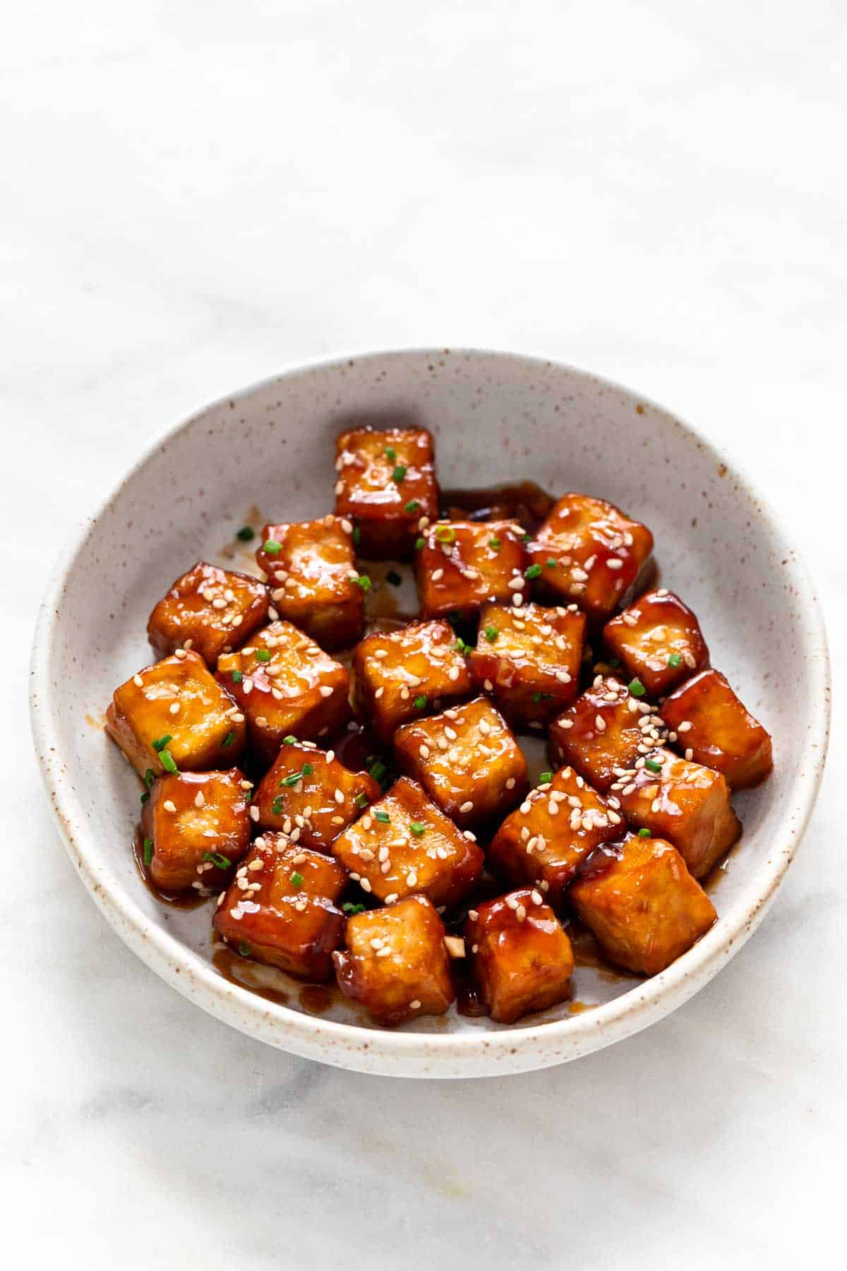 Crispy sesame tofu in a dish.