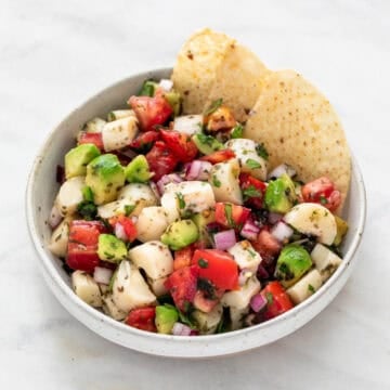 A bowl of vegan ceviche served with tortilla chips.