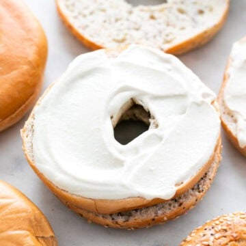 Vegan cream cheese spread on a bagel.