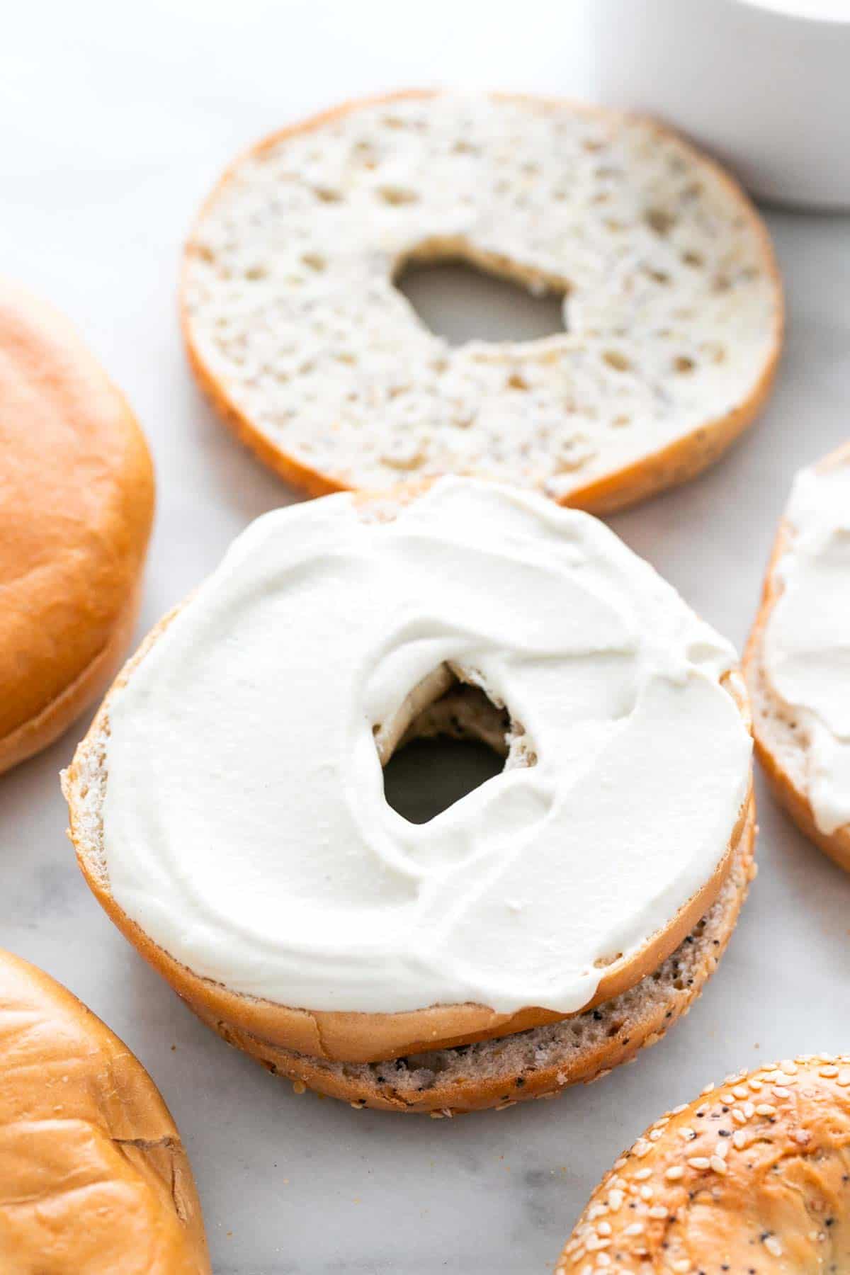 Bagels topped with vegan cream cheese.