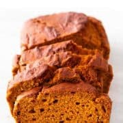 Sliced vegan pumpkin bread on marble.