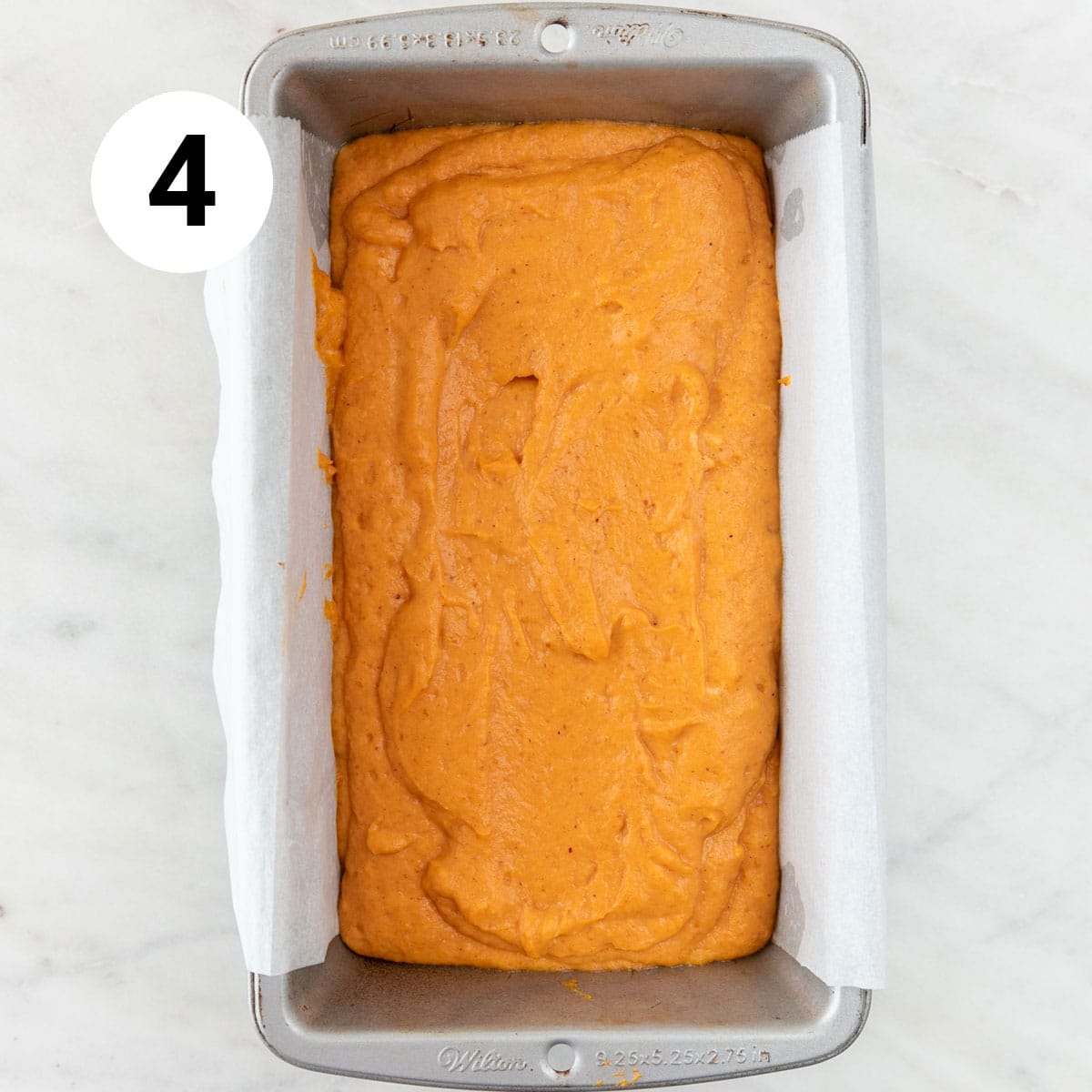 Vegan pumpkin bread batter in the lined loaf pan.