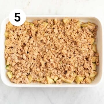 Baking dish with vegan apple crumble before baking.