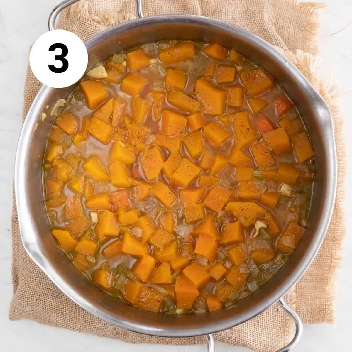 Large pot with cooked vegan butternut squash before blending.