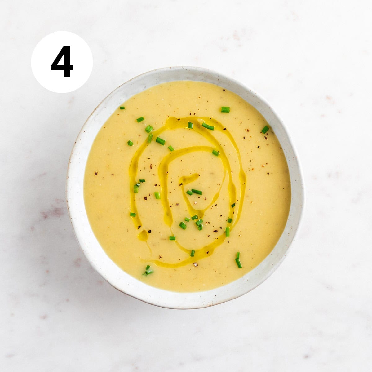 Vegan potato leed soup served in a bowl.