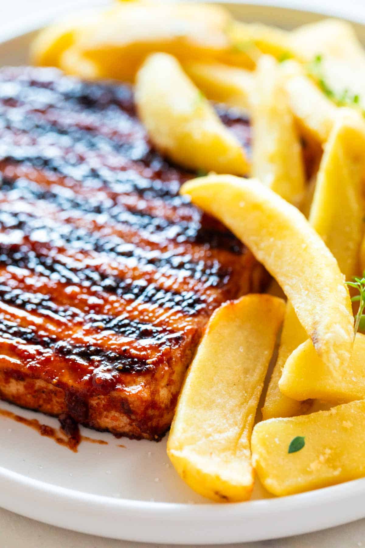 Tofu steak and French fries on a plate.