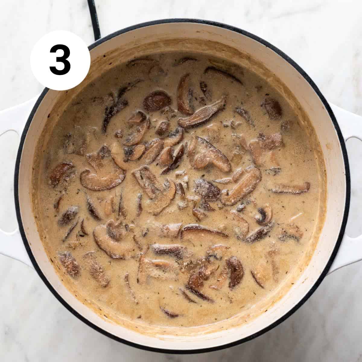 Vegan mushroom soup cooked in a large pot before blending.