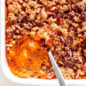 Scooped vegan sweet potato casserole from a baking dish.