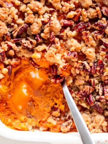 Scooped vegan sweet potato casserole from a baking dish.