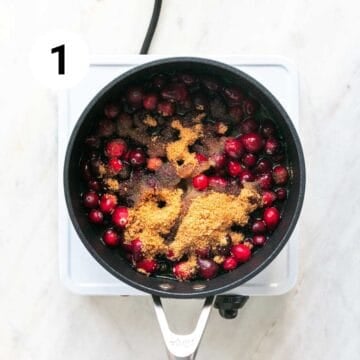 Vegan cranberry sauce ingredients combined in a saucepan.