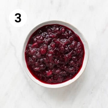 Cooked vegan cranberry sauce in a bowl before cooling and thickening.