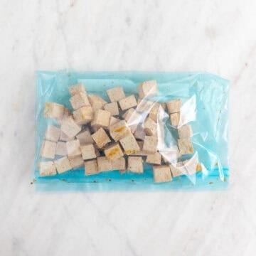 Tofu cubes with soy sauce in a large ziplock bag.