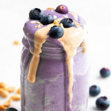 Silken tofu smoothie in a jar with toppings and ingredients arranged around it.