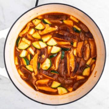 Broth ingredients and veggies in a large pot.