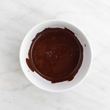 Melted dark chocolate in a bowl.