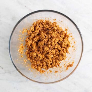 Tofu crumbles with marinade in a bowl.