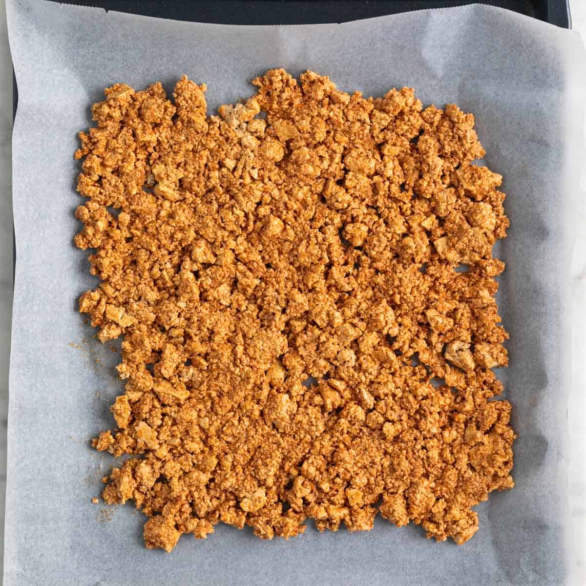 Tofu ground beef in a baking sheet before baking.