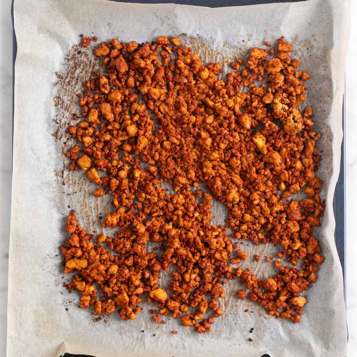 Baked tofu ground beef on a baking sheet.