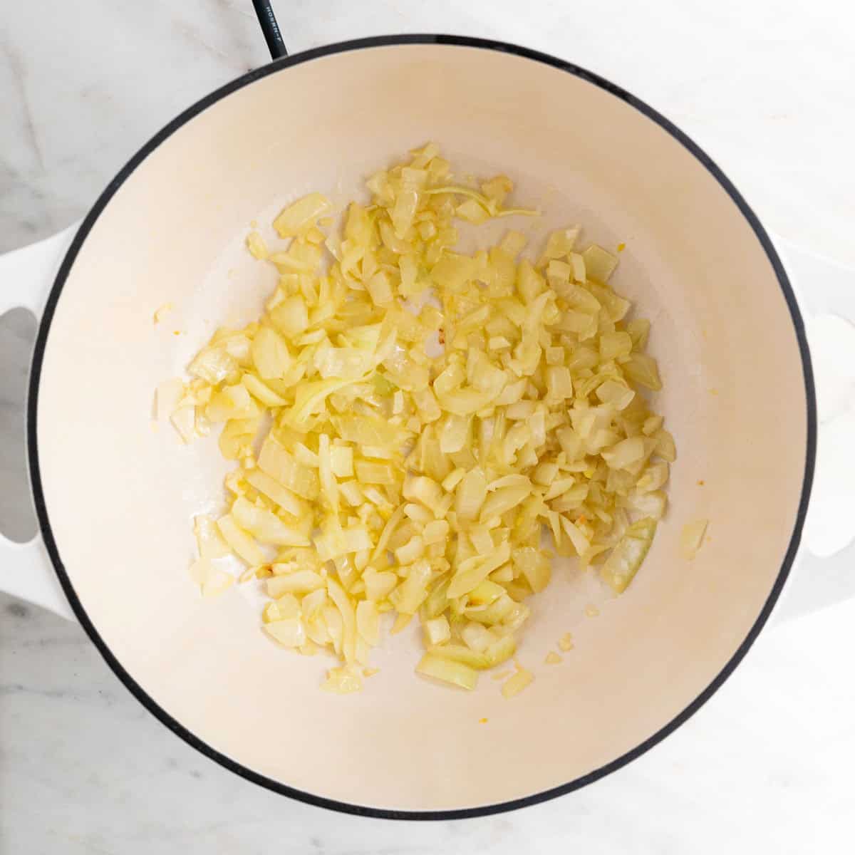 Sautéed garlic and onion in a large pot.