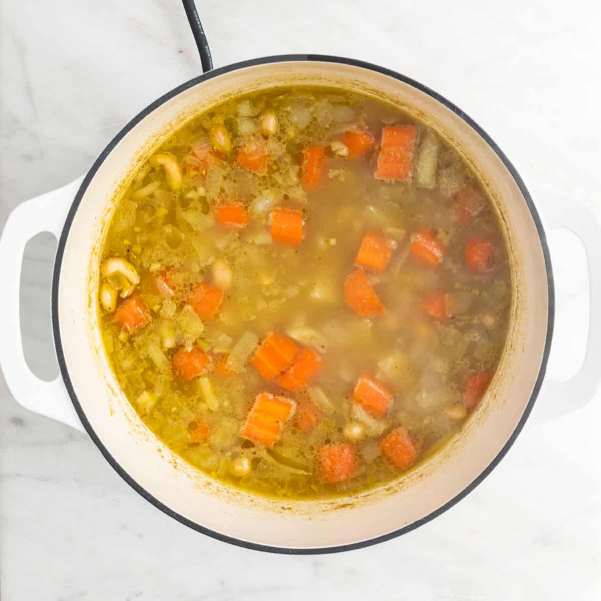 Cooked soup before blending and adding the broccoli and vegan cheese.