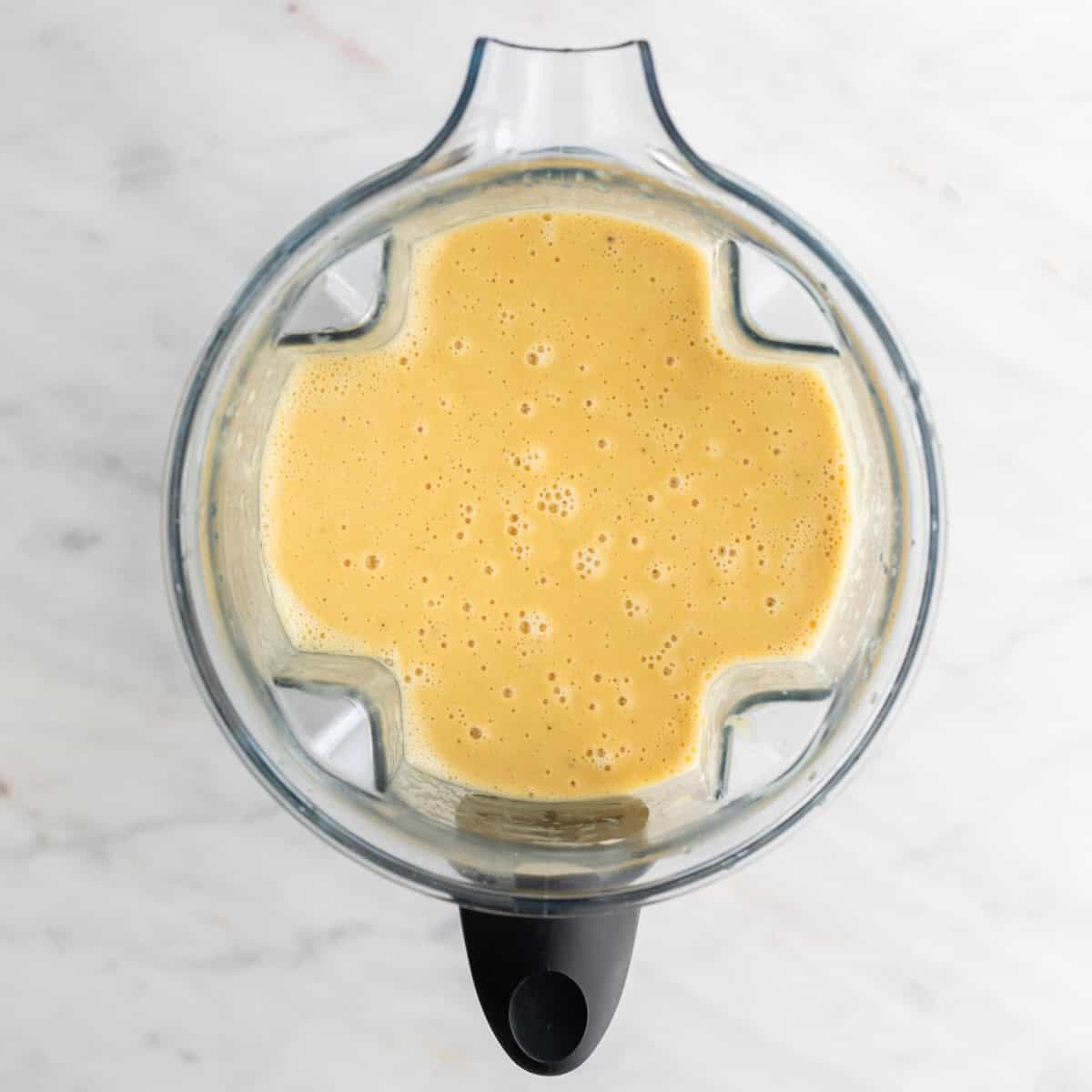 Blended soup in a blender jar before adding the broccoli and vegan cheese.