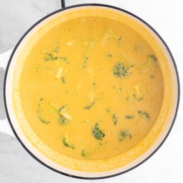 Vegan broccoli cheddar soup in a large pot fully cooked.