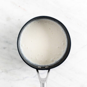 Ingredients for vegan panna cotta mixed in a saucepan.