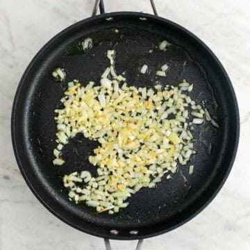 Sautéed onion and garlic in a skillet.