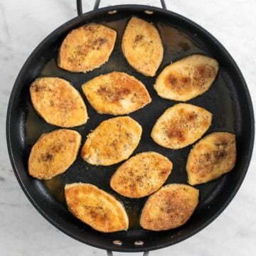 Tofu filets sautéed in a skillet.