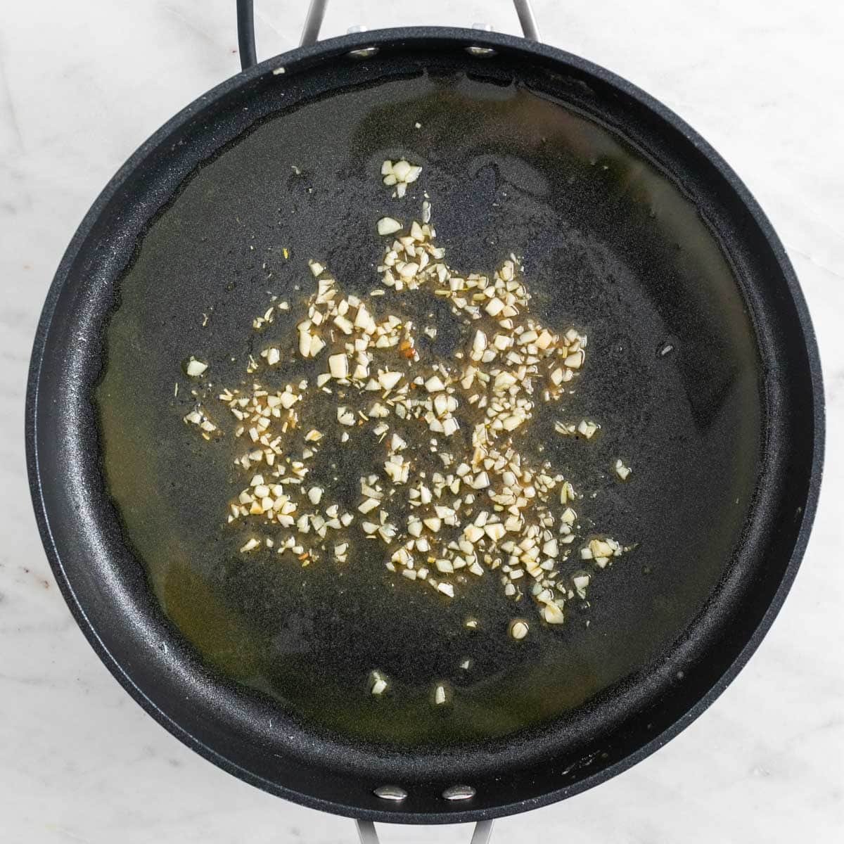Garlic sautéed in a skillet.