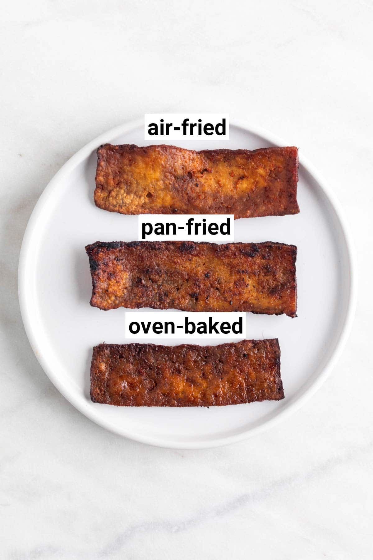 Three slices of tofu bacon, each cooked differently: pan-fried, air-fried, and oven-baked.