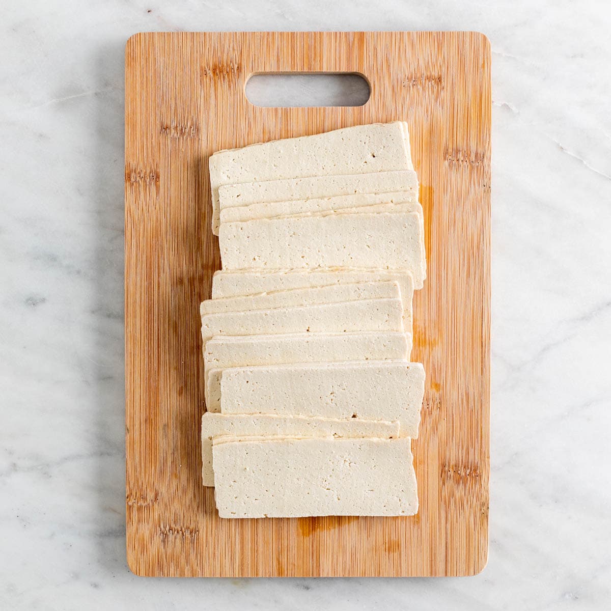 Sliced tofu on a cutting board.