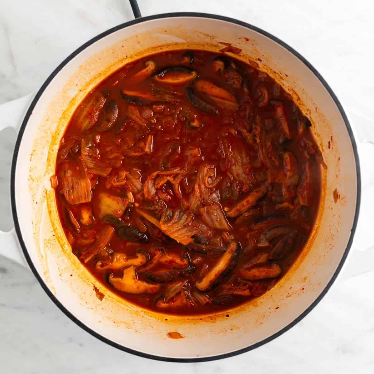 Vegan kimchi stew in a large pot before adding the tofu.
