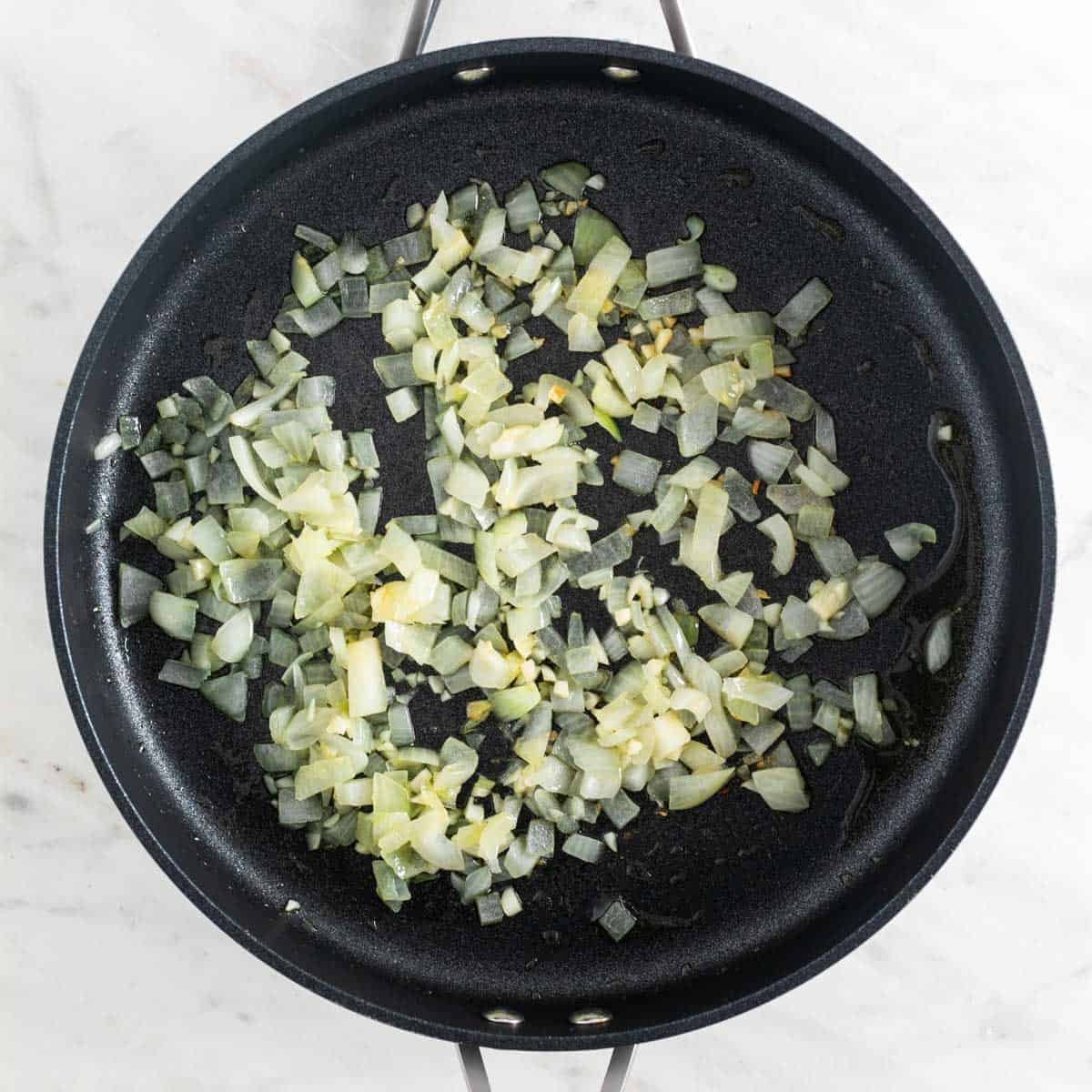 Sautéed onion and garlic in a skillet.