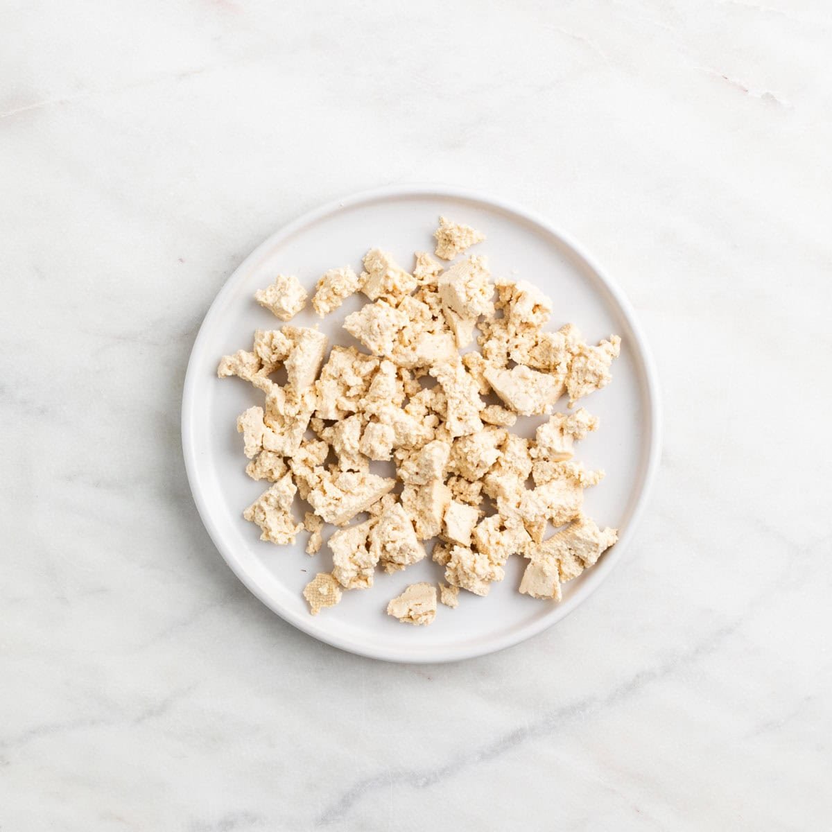 Tofu crumbles on a plate.