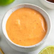 Vegan chipotle mayo in a bowl surrounded by ingredients.
