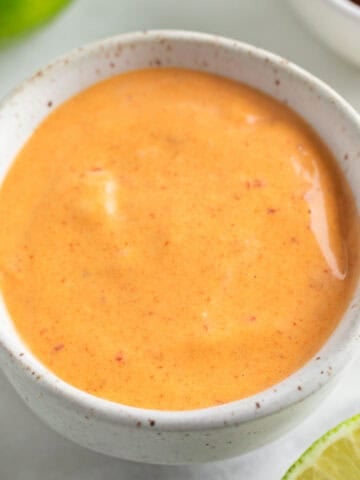 Vegan chipotle mayo in a bowl surrounded by ingredients.