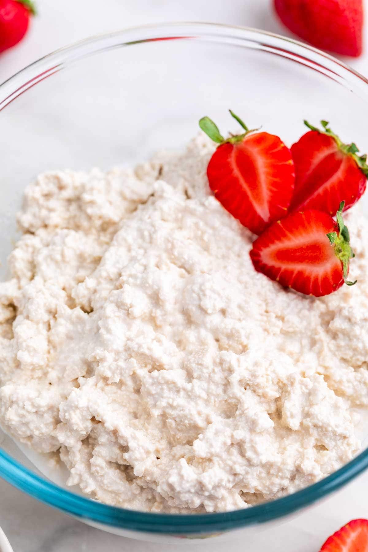 Vegan cottage cheese in a bowl with strawberries.