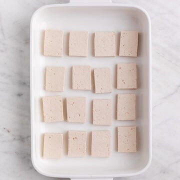Tofu slices in a baking dish.