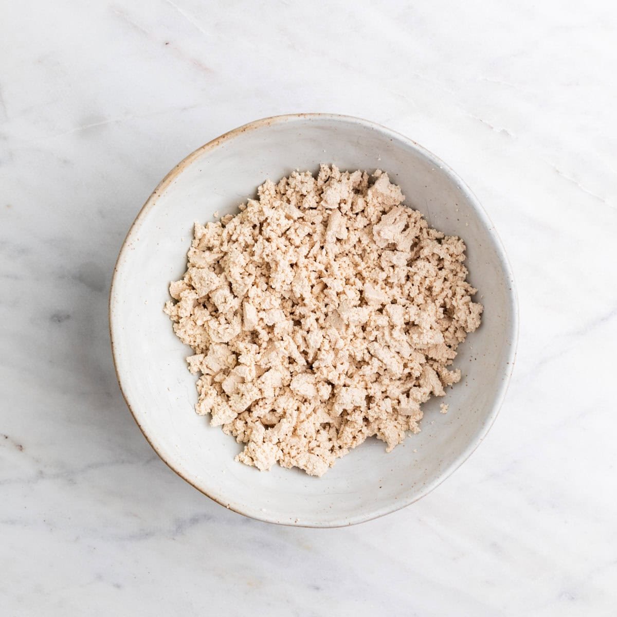 Crumbled tofu in a large bowl.
