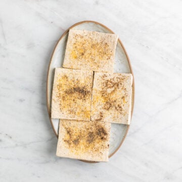 Seasoned tofu pieces on a plate.