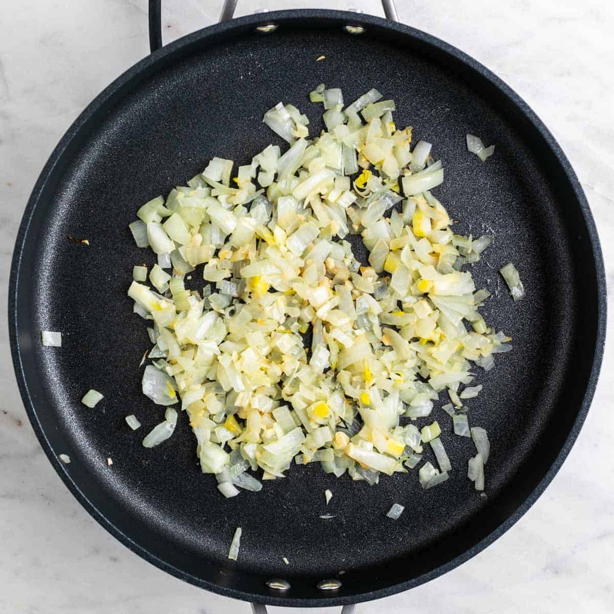 Sautéed onion and garlic in a skillet.