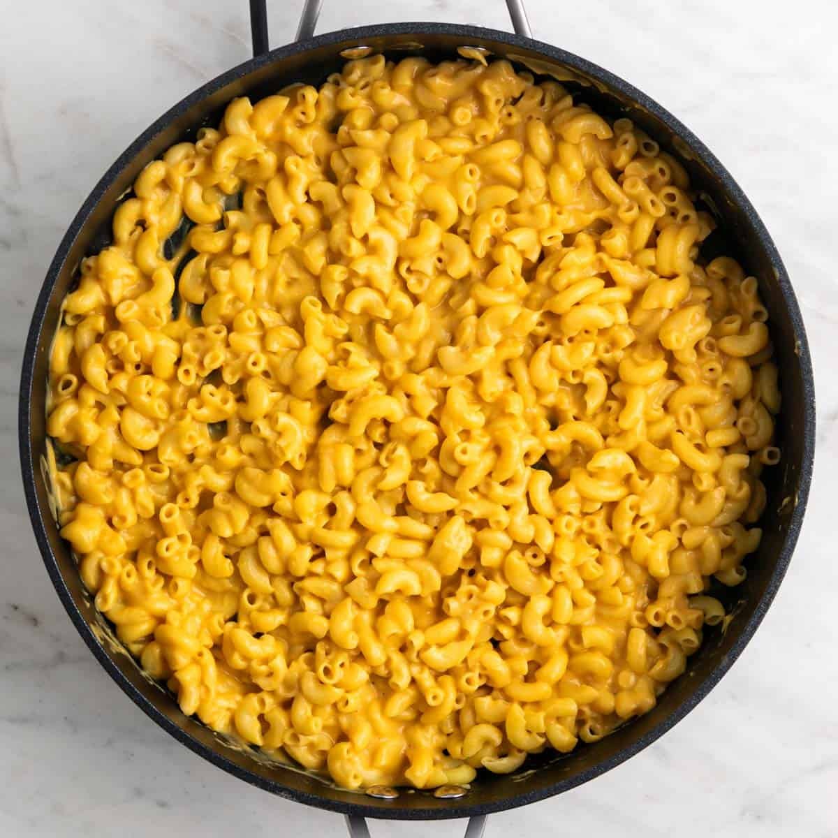 Vegan butternut squash mac and cheese in a skillet.