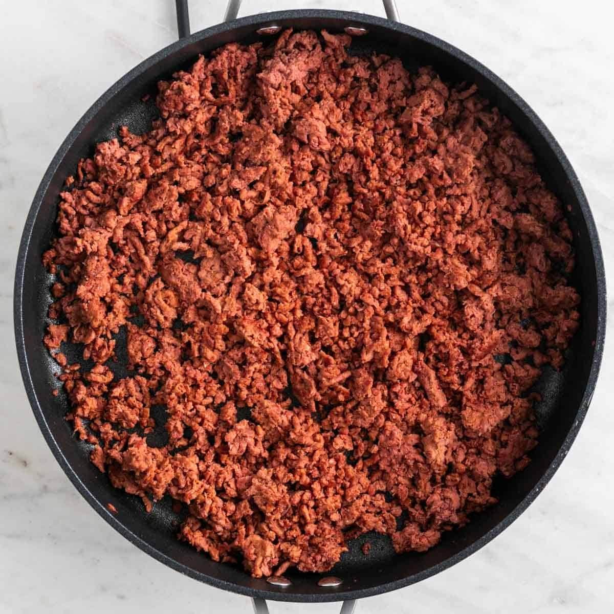 Browned vegan ground beef in a skillet.