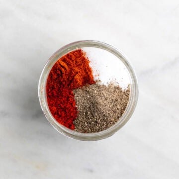 Chicken seasoning ingredients in a jar before mixing.