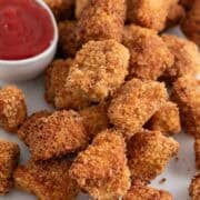 Tofu chicken nuggets with ketchup for dipping.
