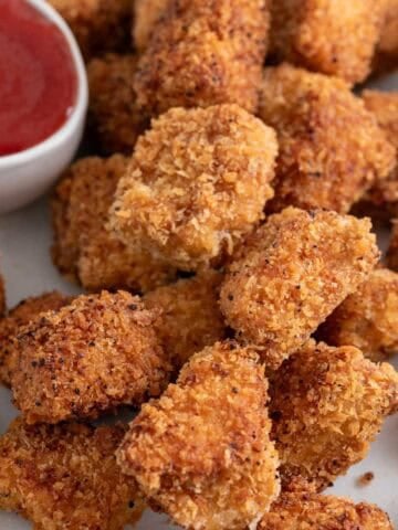 Tofu chicken nuggets with ketchup for dipping.
