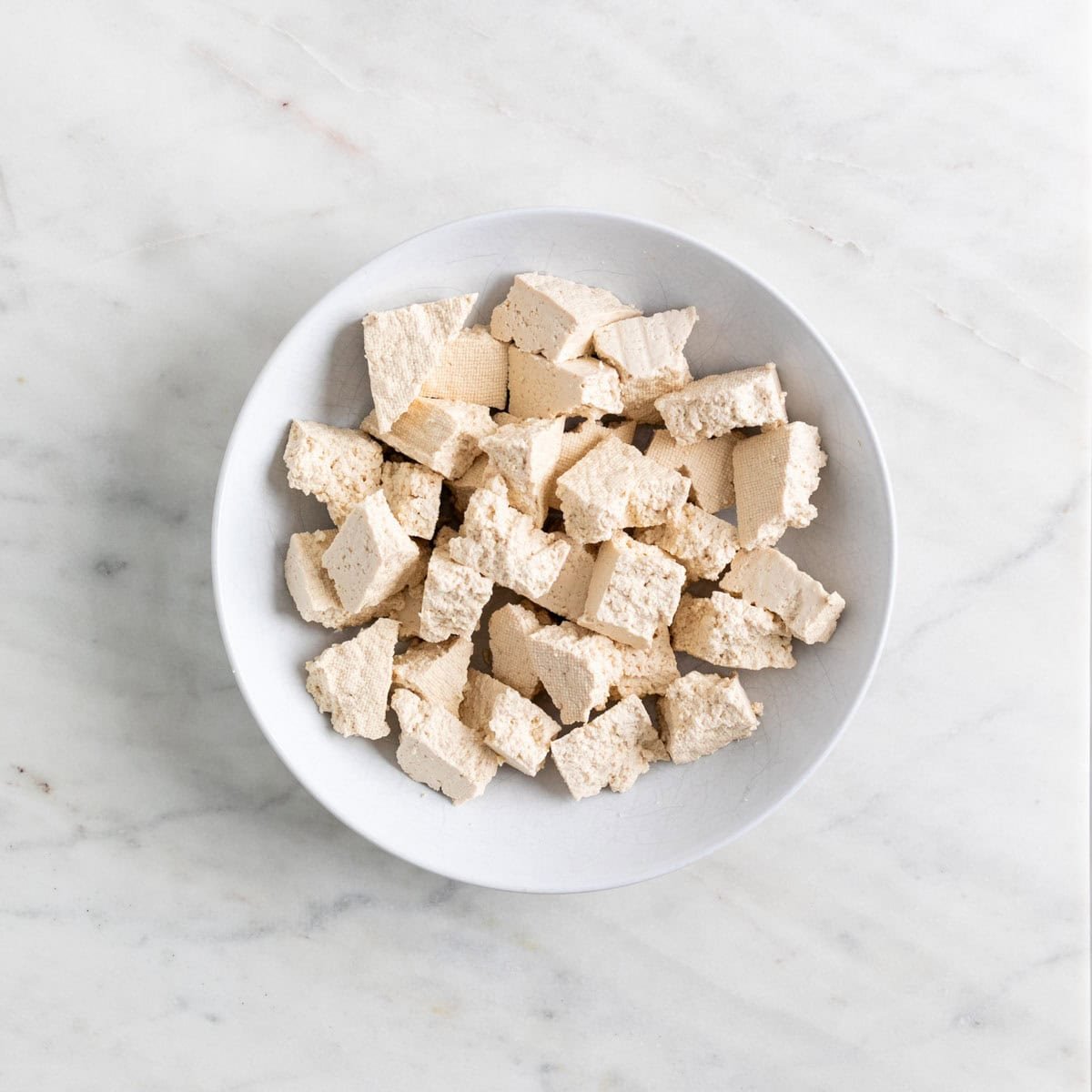 Bowl of tofu chunks.