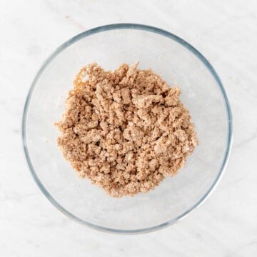 Bowl with vegan apple crisp topping.