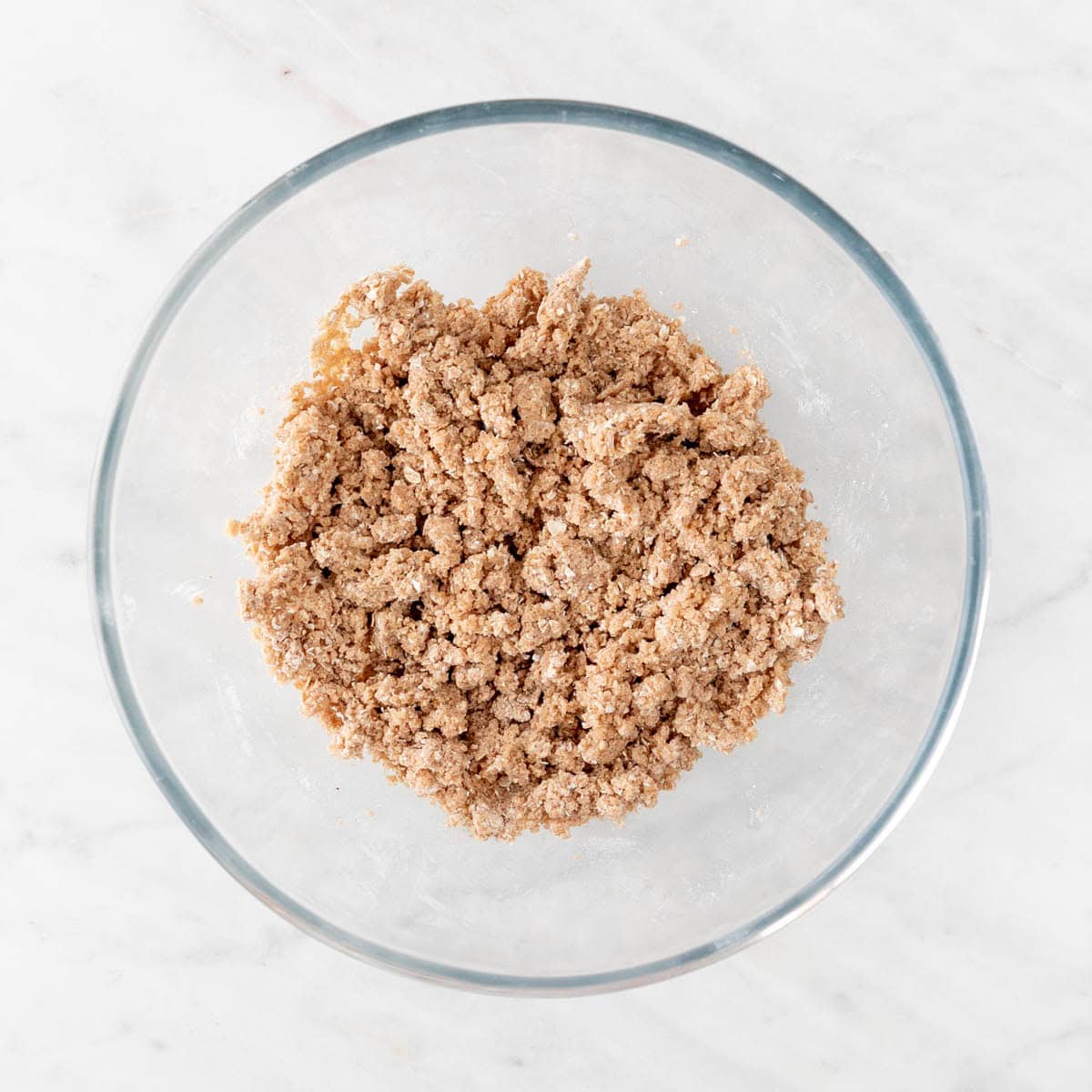 Bowl with vegan apple crisp topping.